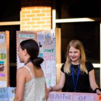Student showing off presentation board.